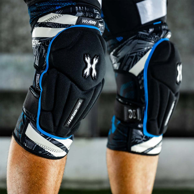 Pair of black and blue HK Army Crash Knee Pads on a player