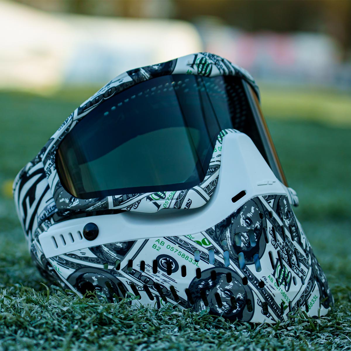 JT ProFlex 100 Dollar Bill Goggle LE with smoke lens on grass