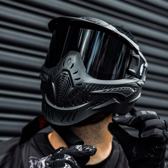 Black HK Army HSTL Thermal Paintball Goggle mask with a smoke lens and white AH logo on the side, shown on a person.