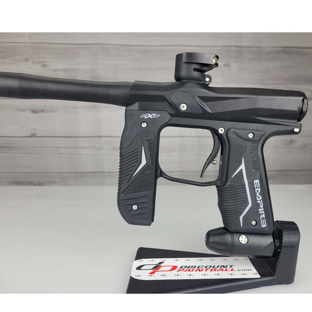 Left side body USED Empire Axe 2.0 Paintball Marker Black on a woodgrain background