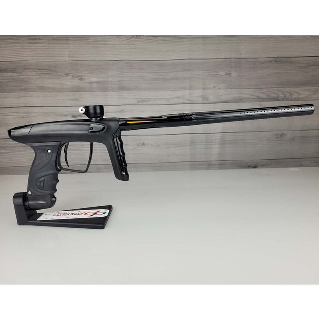 Right side USED DLX Luxe TM40 Paintball Marker Black against a woodgrain background