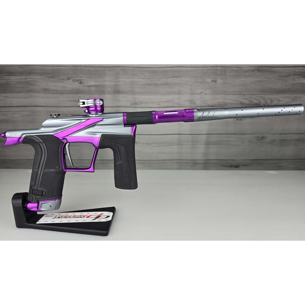 Right side Purple and silver USED Planet Eclipse LV2 Paintball Marker Havoc Grey Purple on a white surface with a wooden background