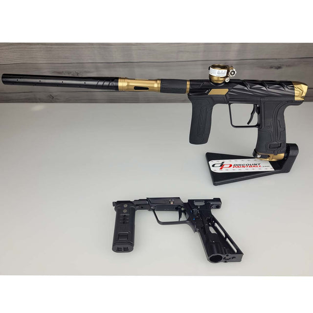 Black and gold USED Planet Eclipse Infamous CS3 paintball marker with a separate black Mech frame on a white surface.
