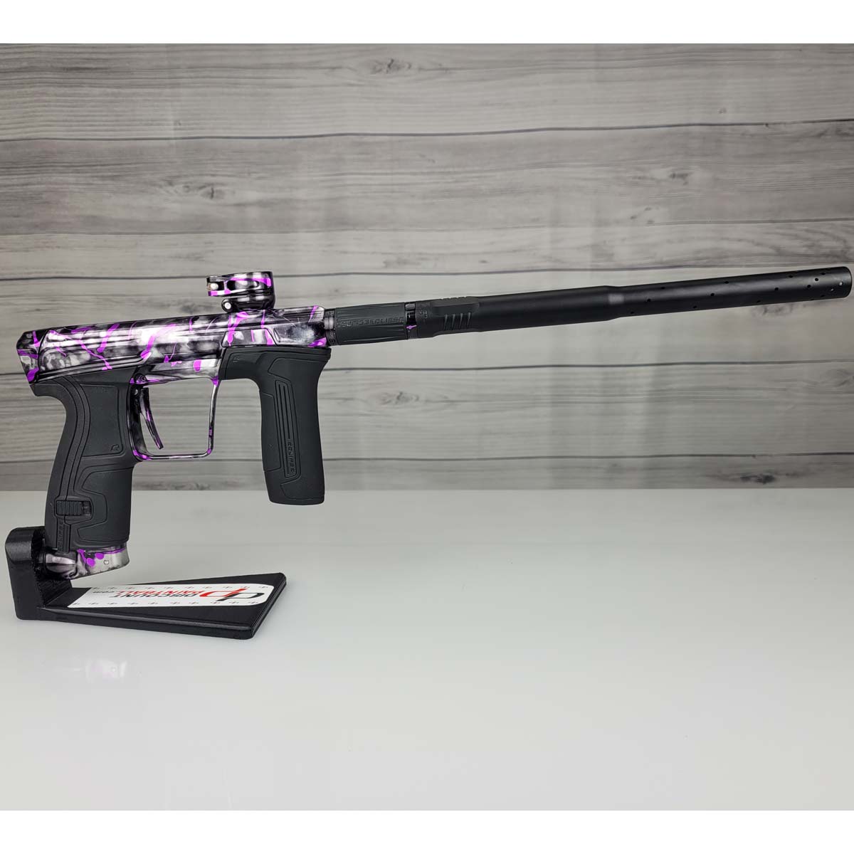 Right side USED Planet Eclipse CS2 Paintball Marker Black Purple Grey Splash on a woodgrain background