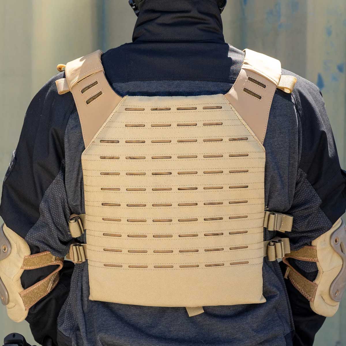 Back of tan BSX Plate Carrier LC for airsoft and paintball with mags on a person dressed in tactical gear