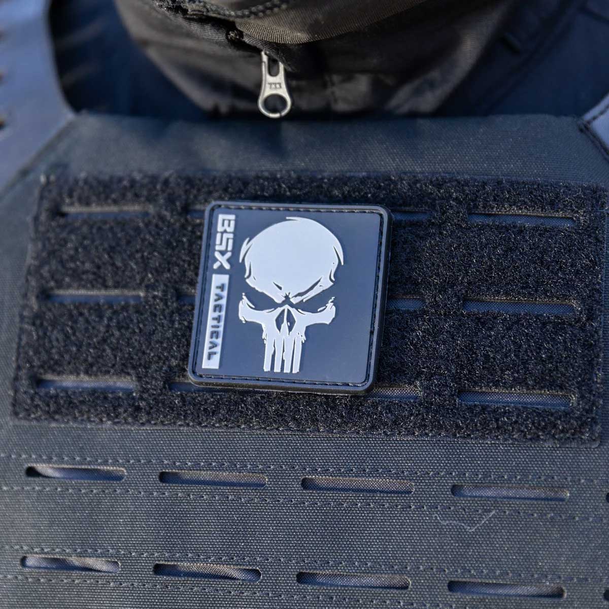 Patch area of black HK Army BSX Skull Plate Carrier for molle attachments for airsoft and paintball, shown on a person