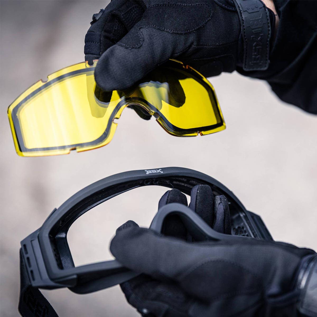 BSX Tango Airsoft Thermal Goggle with Multiple Lens shown uninstalling a yellow lens.