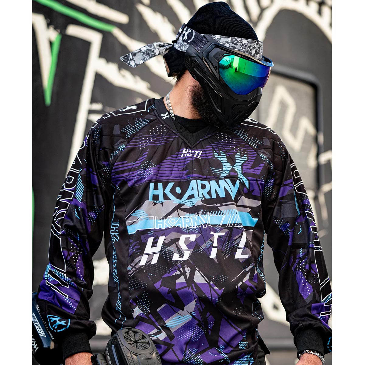 Purple, blue and Black HK Army HSTL Artic long sleeve Jersey on a person on a busy background