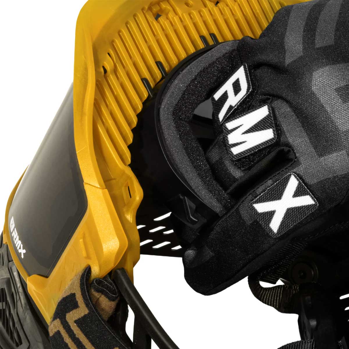 Foam being detached by a gloved hand inside HK Army RMX Thermal Paintball Goggles Black yellow Gold with smoke lens on a white background