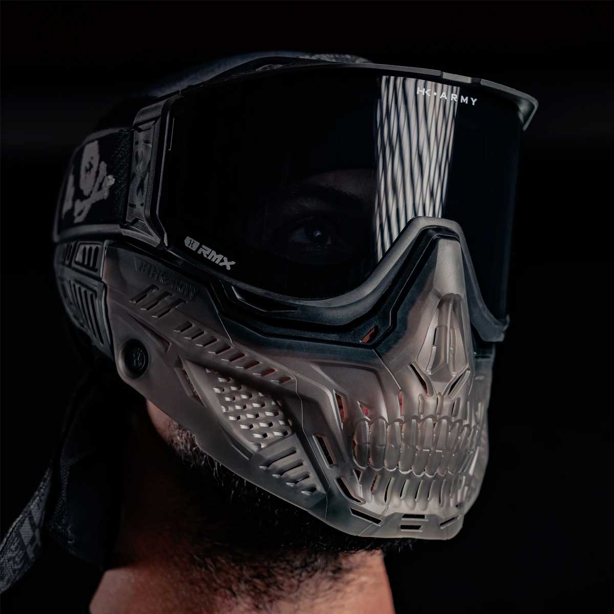 Person wearing a HK Army RMX Lower Terror Ghost Series Goggle Skirt Smoke with lens installed on a dark background
