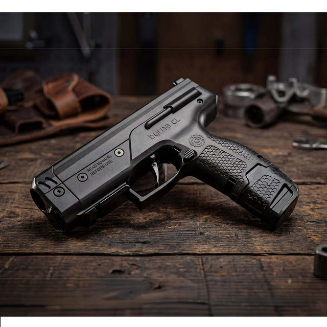 Byrna CL-XL black left side view with 7 round magazine and 12 gram co2 on a wood table