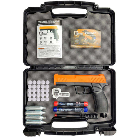 The image shows an open black case holding a .50 caliber Umarex HDP50 Gen 2 P2P Home Defense Pistol with orange accents, accompanied by 12-gram CO2 cartridges, a cleaning rod, a lockable case, and a assortment of round projectiles including pepper rounds.