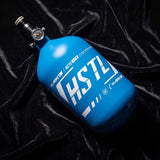 The Blue HK Army HSTL 68ci 4500psi Carbon Fiber Air Tank on a black background