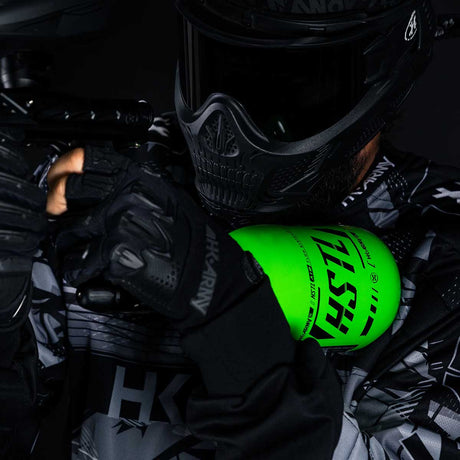 Paintball Player in HK Army gear using the neon green HK Army HSTL 68ci 4500psi Carbon Fiber Air Tank