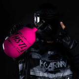 Paintball player holding the pink HK Army HSTL 68ci 4500psi Compressed Air Tank