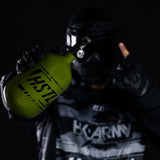 Paintball player holding the Olive HK Army HSTL 68ci 4500psi Compressed Air Tank
