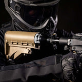 Close up of a person with a A black aluminum HK Army 9ci 3000 PSI high pressure tank with a black regulator shown in a stock.