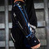 Black blue and white HK Army Crash Elbow Pads for paintball and other sports  on a person