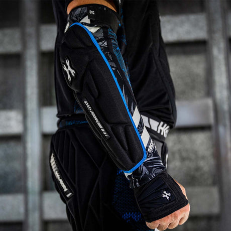 Black blue and white HK Army Crash Elbow Pads for paintball and other sports  on a person