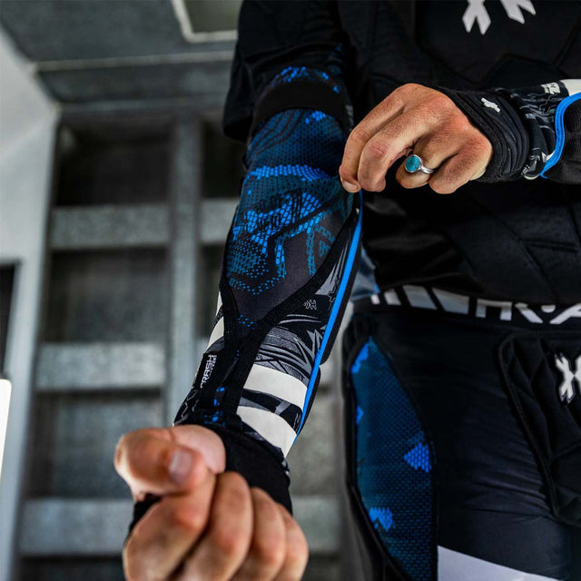 inside of Black blue and white HK Army Crash Elbow Pads for paintball and other sports  on a person