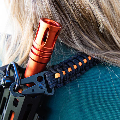 Person wearing a launcher with a Byrna sling mount installed