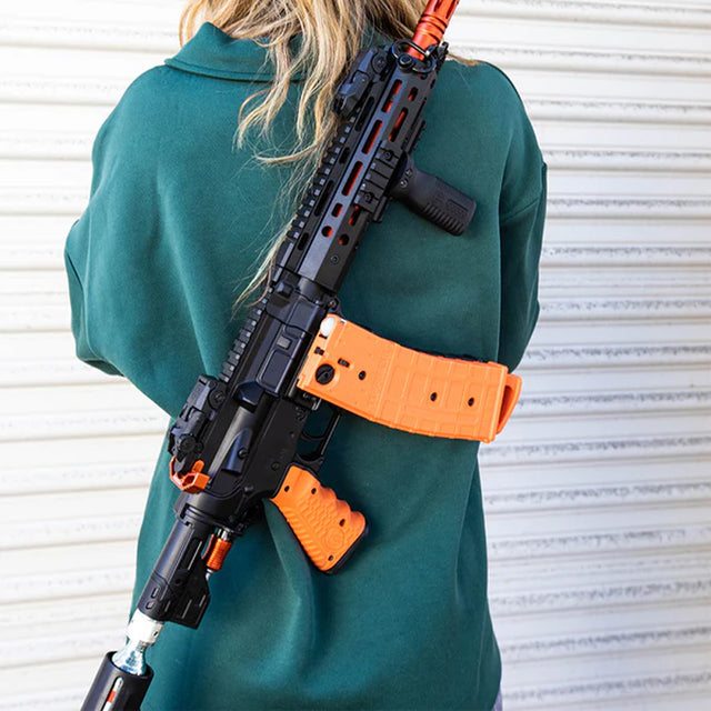 Person holding a launcher with a Byrna sling mount installed