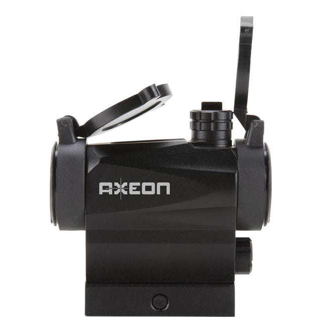 Left side view black AXEON 7XRGB20 Optic Tri Color Dot Sight for rifle mounting on a Picatinny rail with sight covers lifted.
