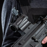 Left side view black AXEON 7XRGB20 Optic Tri Color Dot Sight mounted on a rifle.