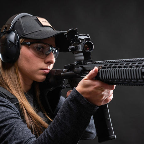 Right side view black AXEON 7XRGB20 Optic Tri Color Dot Sight mounted on a rifle.