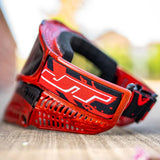 Rear left side view Red and black JT ProFlex Goggle LE Marble Red Black Home paintball mask with a smoke lens on a white background