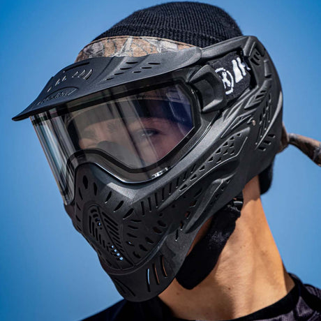 Left side Black HK Army HSTL Thermal Paintball Goggle mask with a clear lens and white AH logo on the side, shown on a person