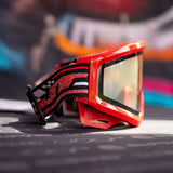 side of JT QLS Goggle Frame w Lens and Strap Brimstone Red for JT Proflex paintball goggle on a busy background