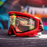 Left side JT QLS Goggle Frame w Lens and Strap Brimstone Red for JT Proflex paintball goggle on a busy background