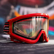 JT QLS Goggle Frame w Lens and Strap Brimstone Red for JT Proflex paintball goggle on a busy background