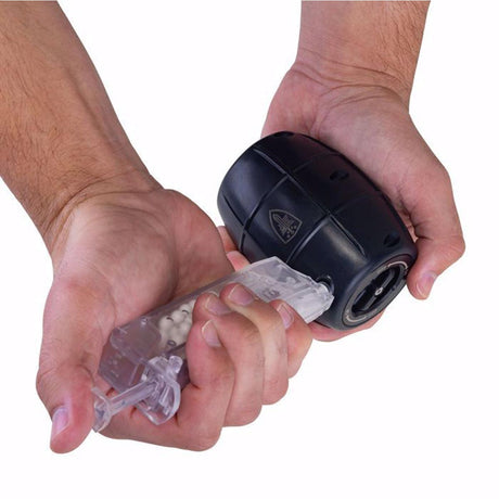 person loading bbs into Elite Force Hailstorm GBB Airsoft Grenade Black on a white background