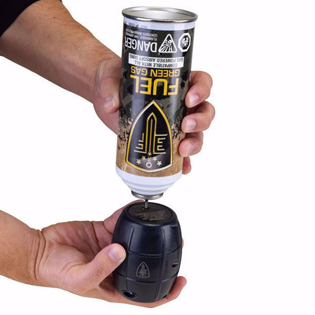 person loading fuel green gas into Elite Force Hailstorm GBB Airsoft Grenade Black on a white background