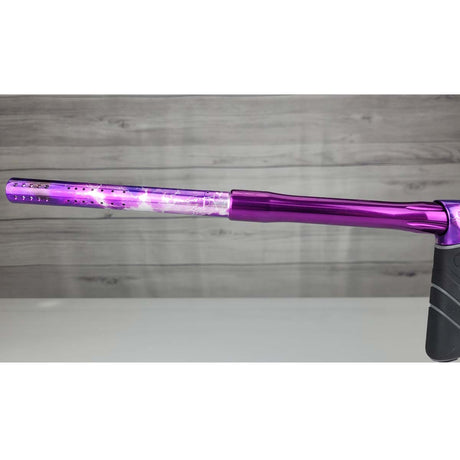 Left side barrel USED DYE DSR Pro PGA Grimace Purple Splash against a wood panel background.
