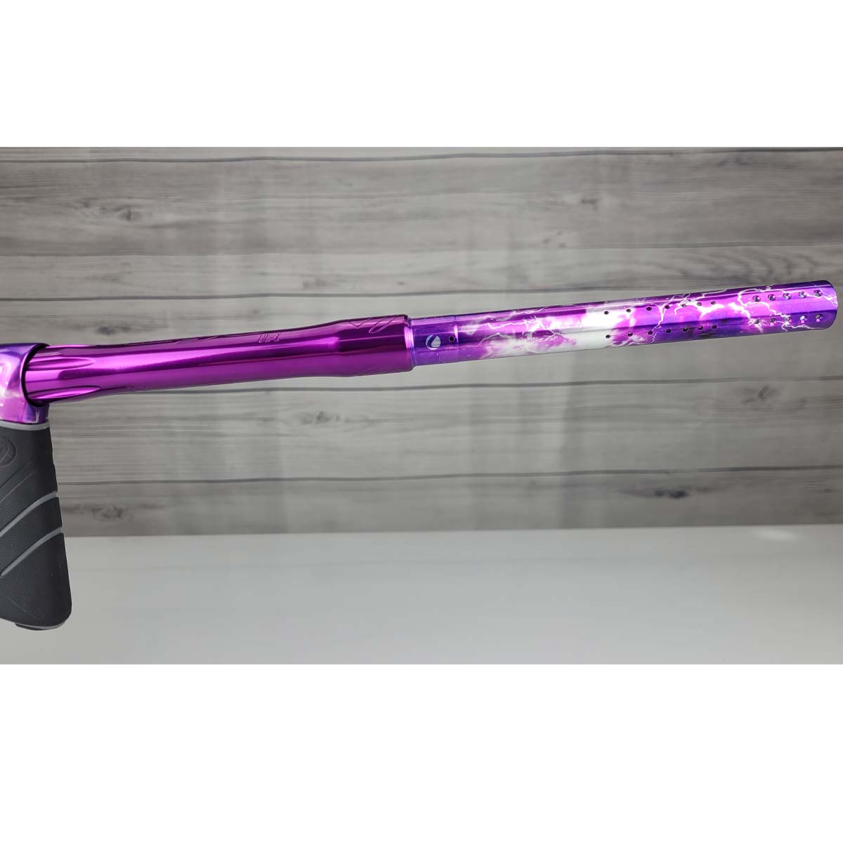 Right side barrel USED DYE DSR Pro PGA Grimace Purple Splash against a wood panel background.