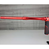 Left side barrel USED Red and black with white splash pattern Dye M3+ Paintball Marker Red Splash on a woodgrain background.