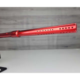 Right side close up of barrel front USED Red and black with white splash pattern Dye M3+ Paintball Marker Red Splash on a woodgrain background.