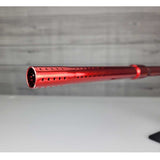 Left side close up of barrel front USED Red and black with white splash pattern Dye M3+ Paintball Marker Red Splash on a woodgrain background.