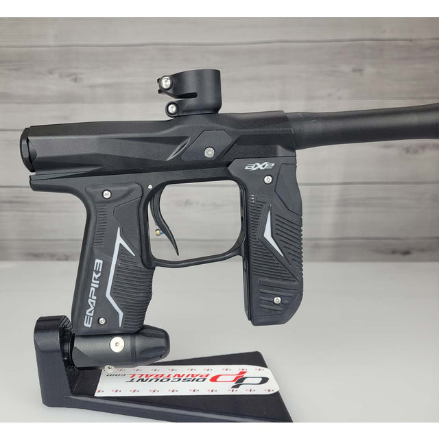 Right side body USED Empire Axe 2.0 Paintball Marker Black on a woodgrain background