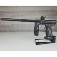 Left side USED Empire Axe 2.0 Paintball Marker Black on a woodgrain background