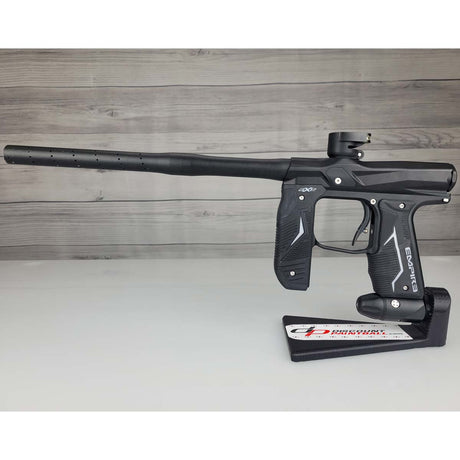 Left side USED Empire Axe 2.0 Paintball Marker Black on a woodgrain background