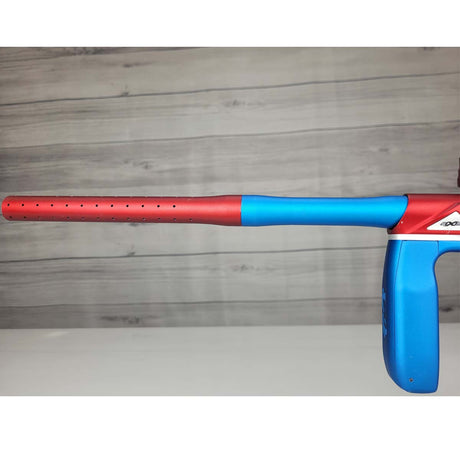Left side barrel USED Empire Axe Pro Red Blue Silver paintball marker on a panel background.