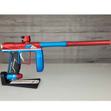 Right side USED Empire Axe Pro Red Blue Silver paintball marker on a panel background.
