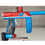 Right side body USED Empire Axe Pro Red Blue Silver paintball marker on a panel background.