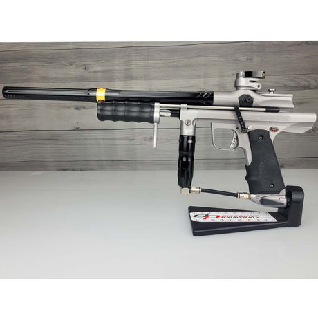 USED Empire Sniper Pump Grey paintball marker with a black and silver design on a white surface with a wooden background