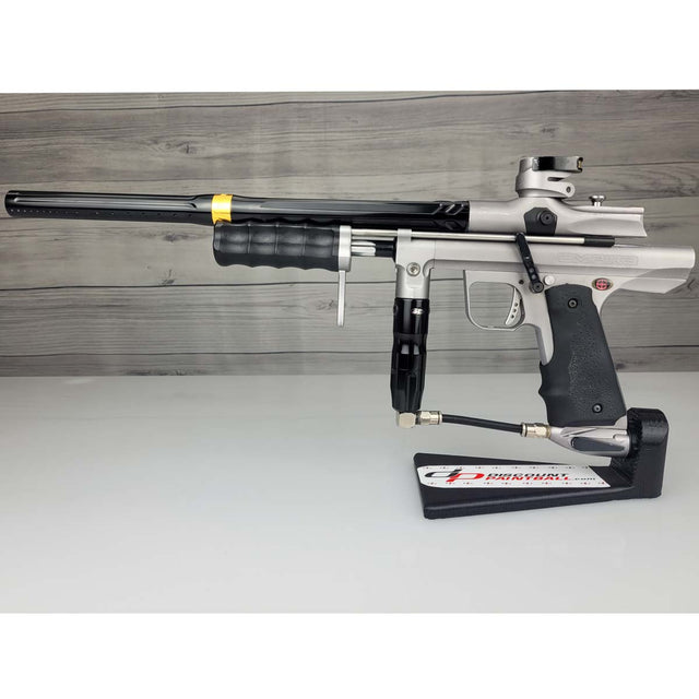 USED Empire Sniper Pump Grey paintball marker with a black and silver design on a white surface with a wooden background