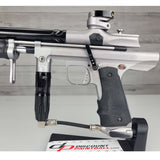 Left side body USED Empire Sniper Pump Grey paintball marker with a black and silver design on a white surface with a wooden background